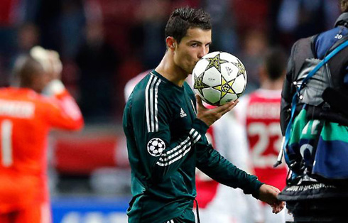 Cristiano Ronaldo kissing the soccer ball and looking at the cameras, after having scored an hat-trick in Ajax vs Real Madrid, for the UEFA Champions League 2012-2013