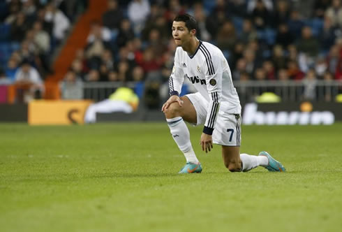 Cristiano Ronaldo standing up after being on his knees, during a game for Real Madrid in La Liga 2012-2013