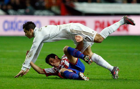 Cristiano Ronaldo being tackled by the Portuguese player, Castro