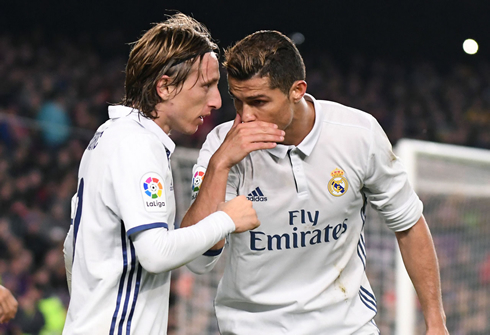 Cristiano Ronaldo whispering and telling Luka Modric a secret