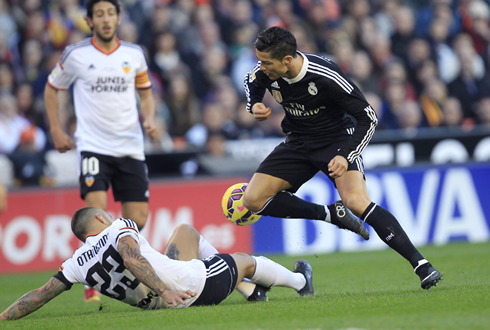 Cristiano Ronaldo trying to escape a sliding tackle from Nicolas Otamendi, in Valencia vs Real Madrid