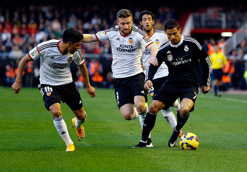 Cristiano Ronaldo running away from several Valencia defenders in La Liga 2015