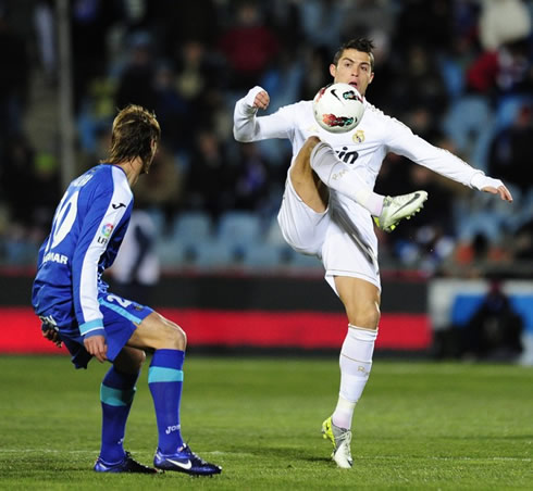 Cristiano Ronaldo holding his balance on his left leg, while he controls the ball with his right foot