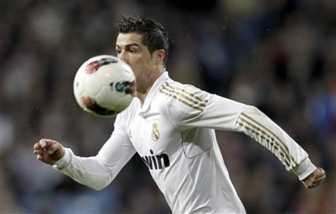 Cristiano Ronaldo running with the ball bouncing close to his head