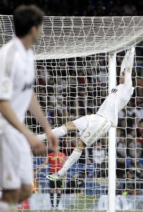 Cristiano Ronaldo holding on Espanyol's goal bar, at the Santiago Bernabéu