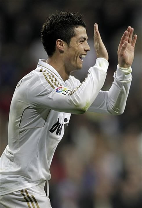 Cristiano Ronaldo smiling and preparing to clap his hands at someone