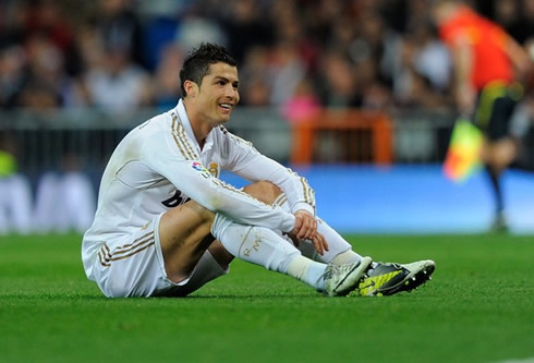 Cristiano Ronaldo sits on the pitch and opens his smile