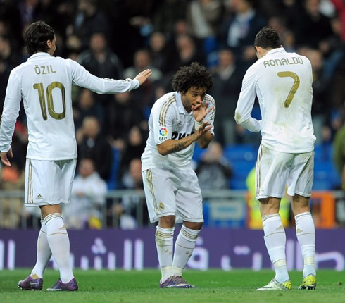Marcelo and Cristiano Ronaldo smoking celebrations, with Mesut Ozil looking at them and laughing