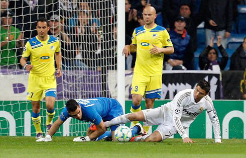 Cristiano Ronaldo on the floor, still trying to reach the ball