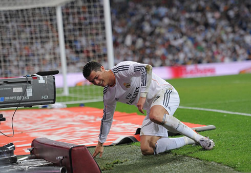 Cristiano Ronaldo on his knees and near to a TV camera during a football game