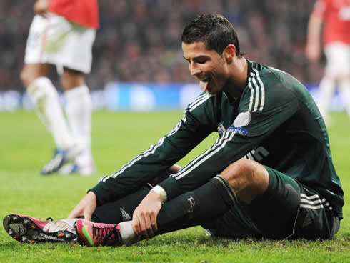 Cristiano Ronaldo stretching his two legs on the pitch at Old Trafford, in Man Utd 1-2 Real Madrid, for the Champions League second leg