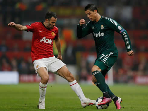 Cristiano Ronaldo taking on Ryan Giggs, in Manchester United vs Real Madrid, for the UEFA Champions League 2013