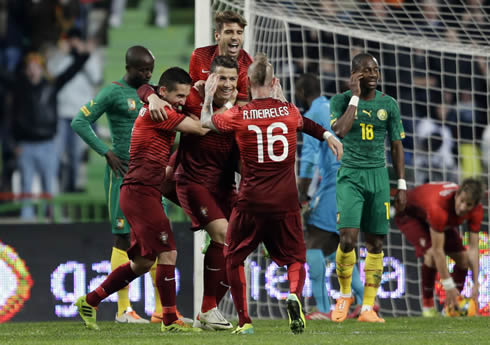 Cristiano Ronaldo with Miguel Veloso jumping on his back and Raúl Meireles about to meet them