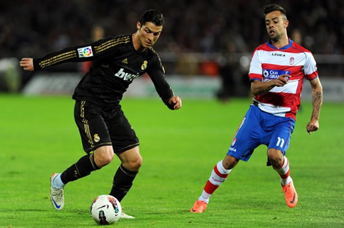 Cristiano Ronaldo preparing to take off and leave a Granada defender behind, in a Real Madrid game in 2012