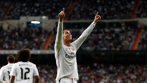 Cristiano Ronaldo sticking his two fingers up in the air after scoring a goal for Real Madrid