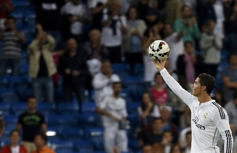 Cristiano Ronaldo showing the hat-trick match ball to the fans at the Bernabéu