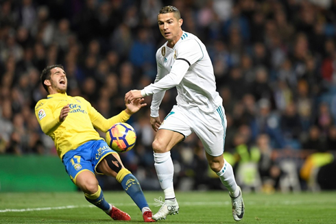 Cristiano Ronaldo sends an opponent to the ground and chases the ball