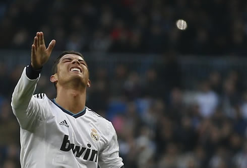 Cristiano Ronaldo closing his eyes and stretching his right arm, in a game for Real Madrid in 2013