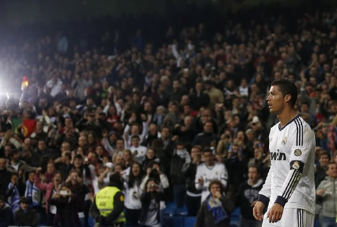 Cristiano Ronaldo at the Santiago Bernabéu with a Portuguese flag on the background, playing for Real Madrid, in 2013