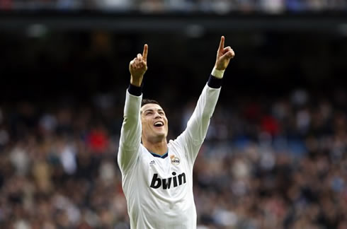 Cristiano Ronaldo raising his two fingers to the air, celebrating a Real Madrid goal in 2013