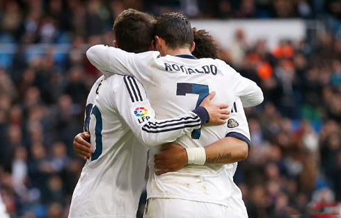 Cristiano Ronaldo hugging Mesut Ozil and Marcelo, after Real Madrid had just scored a goal against Levante, in La Liga 2013