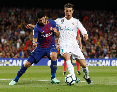 Cristiano Ronaldo fighting for the ball with Luis Suárez