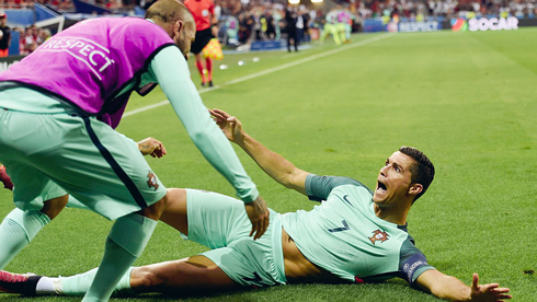Cristiano Ronaldo sliding on the grass into Ricardo Quaresma arms