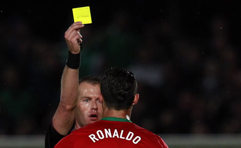 Cristiano Ronaldo seeing a yellow card from a Dutch referee after he defended Hélder Postiga