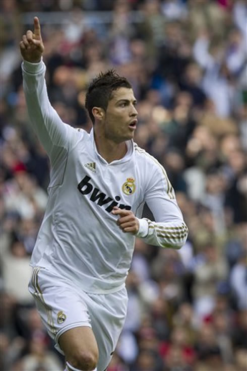 Cristiano Ronaldo raises his finger while he runs to celebrate a goal