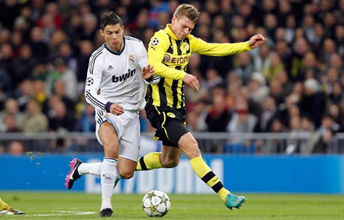 Cristiano Ronaldo being charged by a Borussia Dortmund midfielder, in a Champions League fixture in 2012-2013