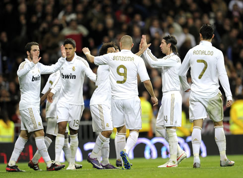 Cristiano Ronaldo looking distant while Real Madrid players, Higuaín, Varane, Marcelo, Benzema and Sergio Ramos celebrate a goal