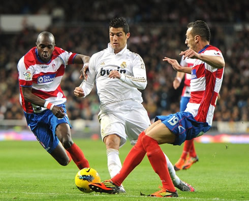 Cristiano Ronaldo being stopped when attempting to dribble two defenders