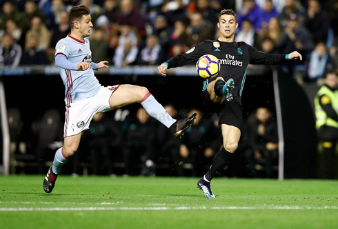 Cristiano Ronaldo stretching his right leg to reach the ball first