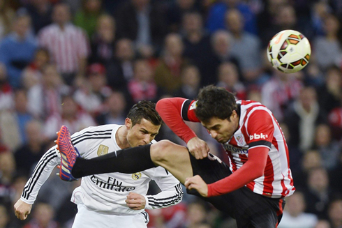 Cristiano Ronaldo shows his courage as he heads the ball with near the elbow of an opponent