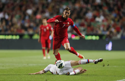 Cristiano Ronaldo leaving a defender on the ground and stepping over him during a sprint, in Portugal vs Russia for the 2014 FIFA World Cup qualifying stage