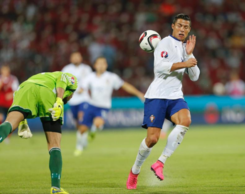 Cristiano Ronaldo avoids clashing with Albania's goalkeeper, in a EURO 2016 qualifier