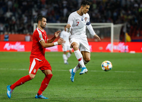 Cristiano Ronaldo in the air making a pass