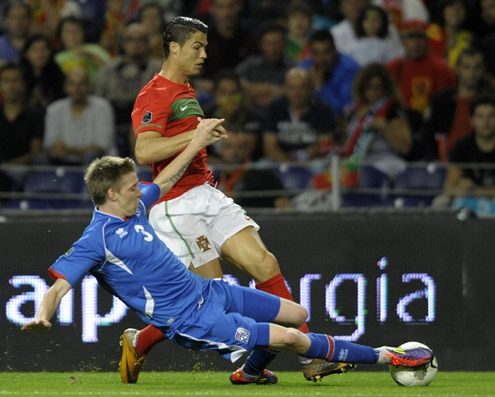Cristiano Ronaldo being tackled in the match between Portugal and Iceland, in the Dragon Stadium