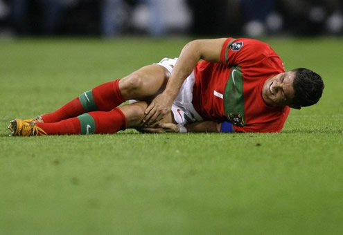 Cristiano Ronaldo layed on the ground complaining about a touch on his right thigh