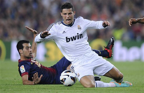 Cristiano Ronaldo going down after a tackle from Sergio Busquets, in Barcelona vs Real Madrid, for La Liga 2012-2013