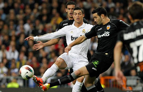 Cristiano Ronaldo trying to steal a boal from a Valencia opponent