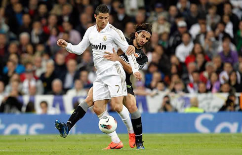 Cristiano Ronaldo holding the ball while being fouled in 2012