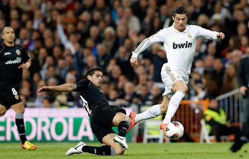 Cristiano Ronaldo jumping over a defender as he dribbles in great speed, Real Madrid in 2012