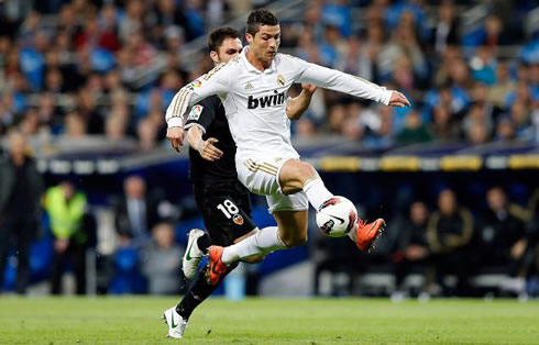 Cristiano Ronaldo being fouled from behind, as he receives a ball in the air