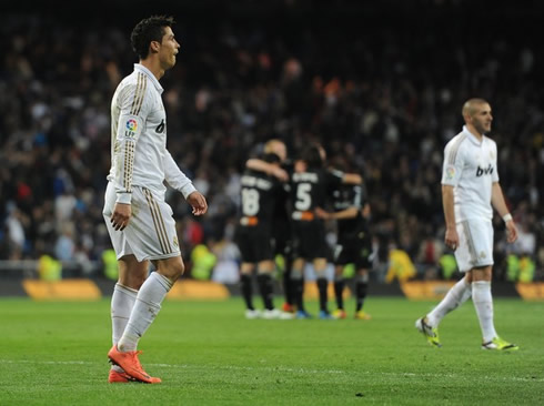 Cristiano Ronaldo walking away from the Santiago Bernabéu with Benzema, as Valencia celebrate their draw