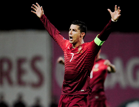 Cristiano Ronaldo raising his two arms in celebration, in Portugal 1-0 Denmark