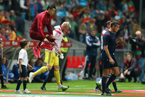 Cristiano Ronaldo jumping extremely high in his warm-up routine before the kickoff of a game