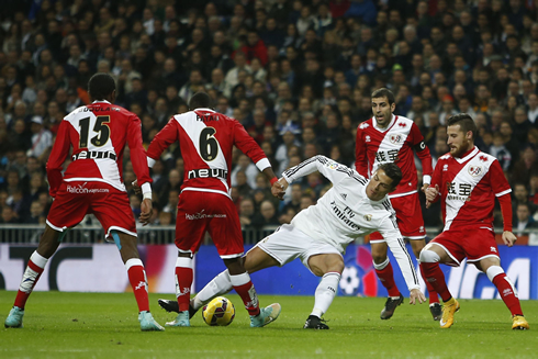 Cristiano Ronaldo struggling to keep his balance while surrounded by multiple defenders