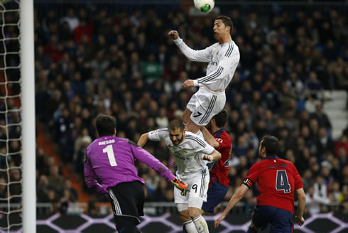 Cristiano Ronaldo jumping over Karim Benzema in a Real Madrid game in 2014