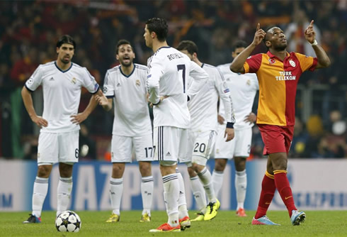 Cristiano Ronaldo asking for explanations to his teammates, at the same time Didier Drogba celebrates Galatasaray third goal against Real Madrid, in 2013